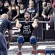 CrossFit and weightlifter doing a heavy squat clean at a competition
