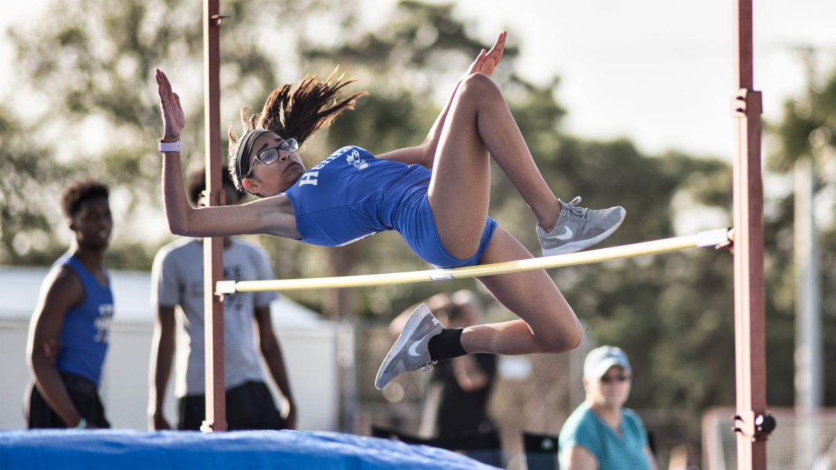 Track & field athlete jumping over a pole