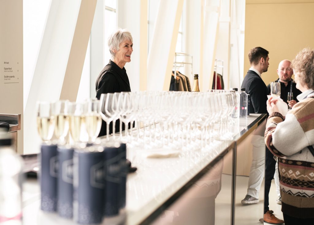 Waitress smiling at the bar of a cocktail event