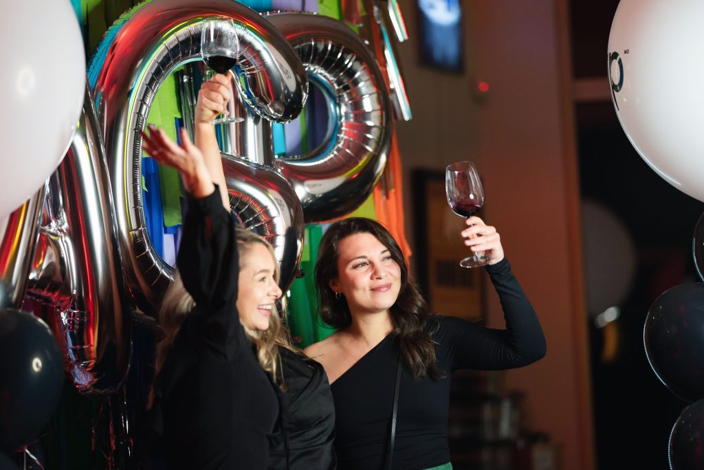 Participants cheering and celebrating at a cocktail event