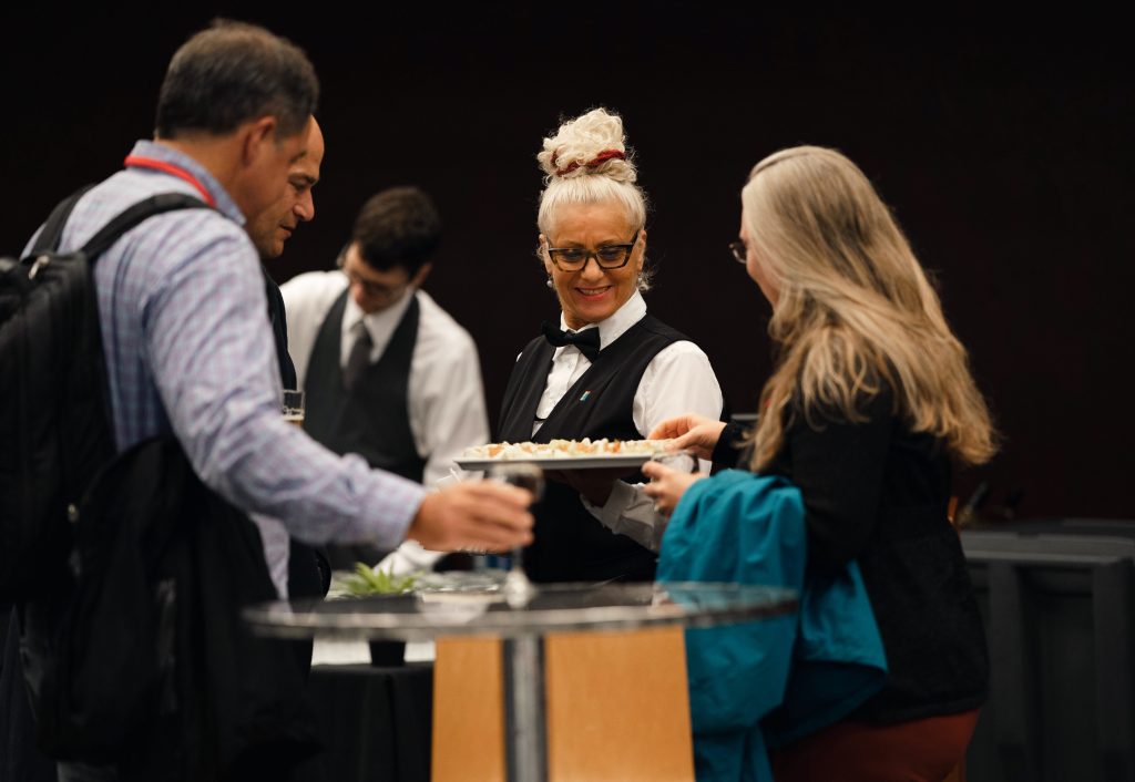 Staff offering appetizers at a cocktail event