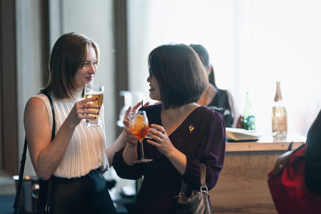 Participants smiling at a cocktail event