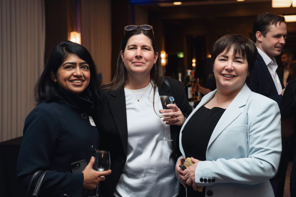 Participants smiling at a networking event